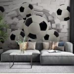 Wall murals Soccer balls breaking through wall