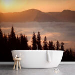 Wall murals Group of trees with clouds and mountains in the background