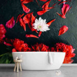 Wall murals Group of red flowers with petals on a black surface