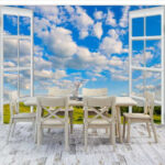Wall murals Window with a blue sky and clouds