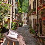 Wall murals Charming alley with vibrant flowers.