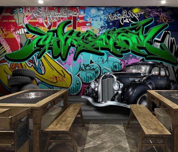 Black car with wheels in front of a colorful wall Wall murals Black car with wheels in front of a colorful wall