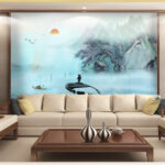 Wall murals Man standing on a boat in water with mountains and trees