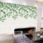 Wall murals White brick wall with green leaves