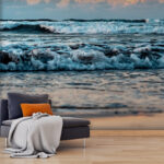 Wall murals Waves dance under a sunrise sky.