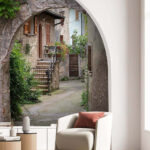Wall mural Charming stone alley with archway