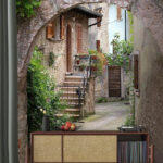 Wall murals Charming stone alley with archway.