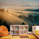 Wall murals Foggy landscape with trees and mountains