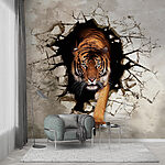 Wall mural Tiger emerging through cracked wall
