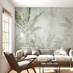 Wall mural Textured tropical leaves on concrete background