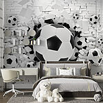 Wall mural Soccer balls burst through the wall